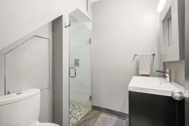 a bathroom with a sink toilet and shower