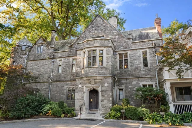 a front view of a house with plants