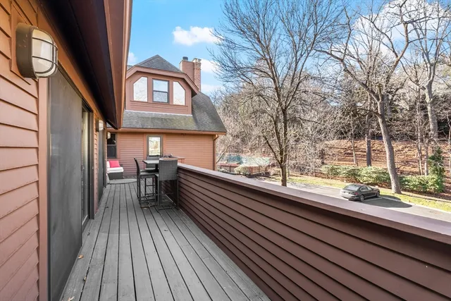 a view of roof deck with a barbeque and wooden stairs