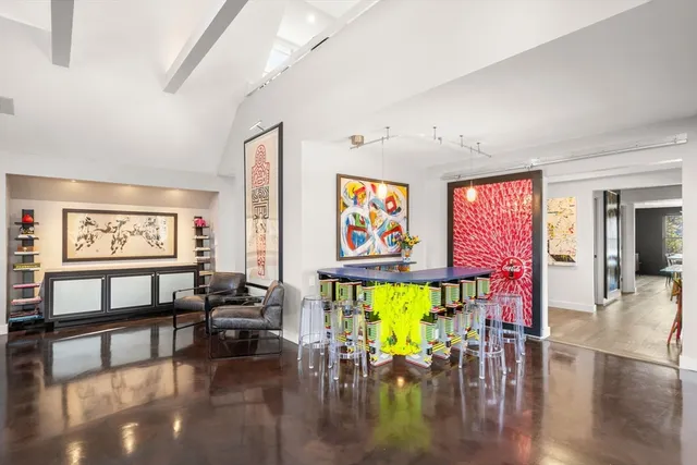 a living room with furniture and floor to ceiling window