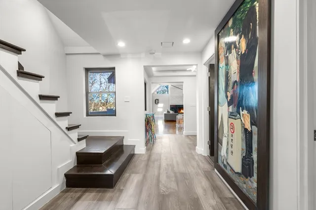 a view of entryway and hall with wooden floor
