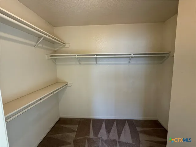 a view of an empty walk in closet