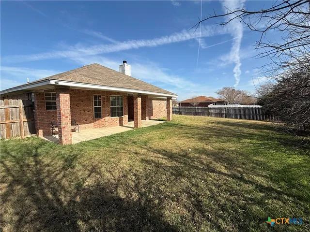 a view of house with a ceiling fan