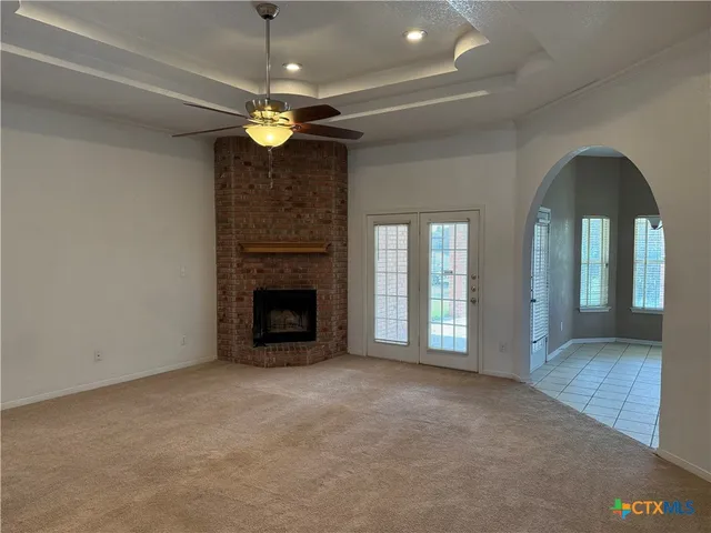 a view of a livingroom with a fireplace and window