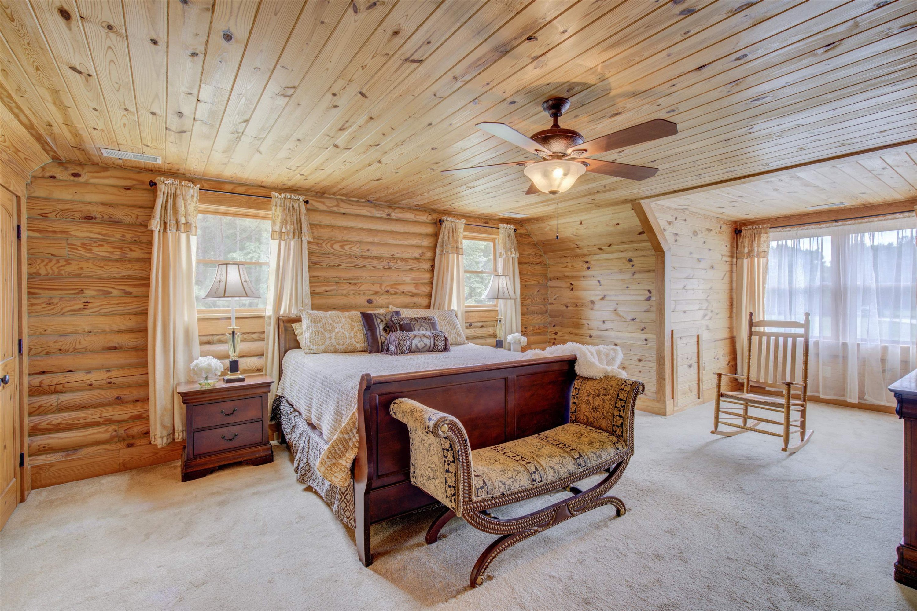 1039 North Chavis Road Kittrell, NC 27544 - Photo 11 of 53 a spacious bedroom with a bed and a chandelier