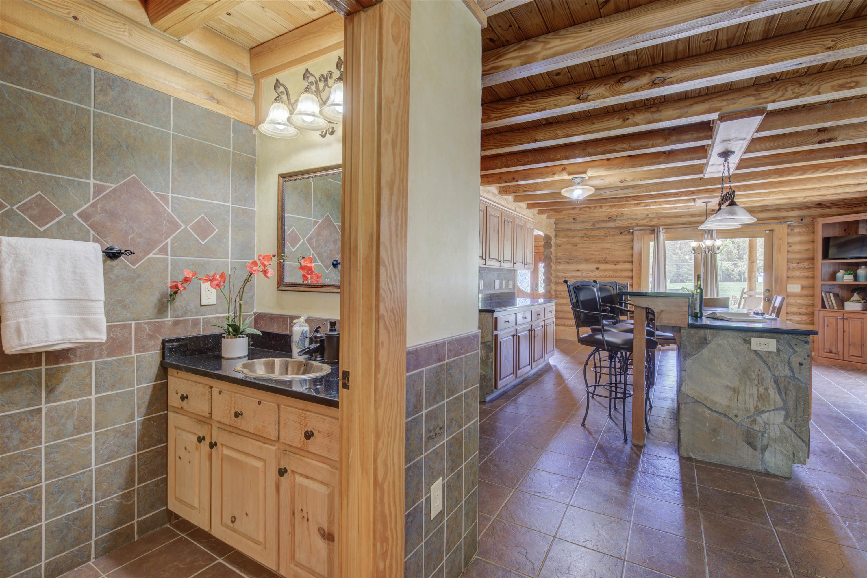 1039 North Chavis Road Kittrell, NC 27544 - Photo 20 of 53 a kitchen with stainless steel appliances kitchen island granite countertop a table and chairs in it