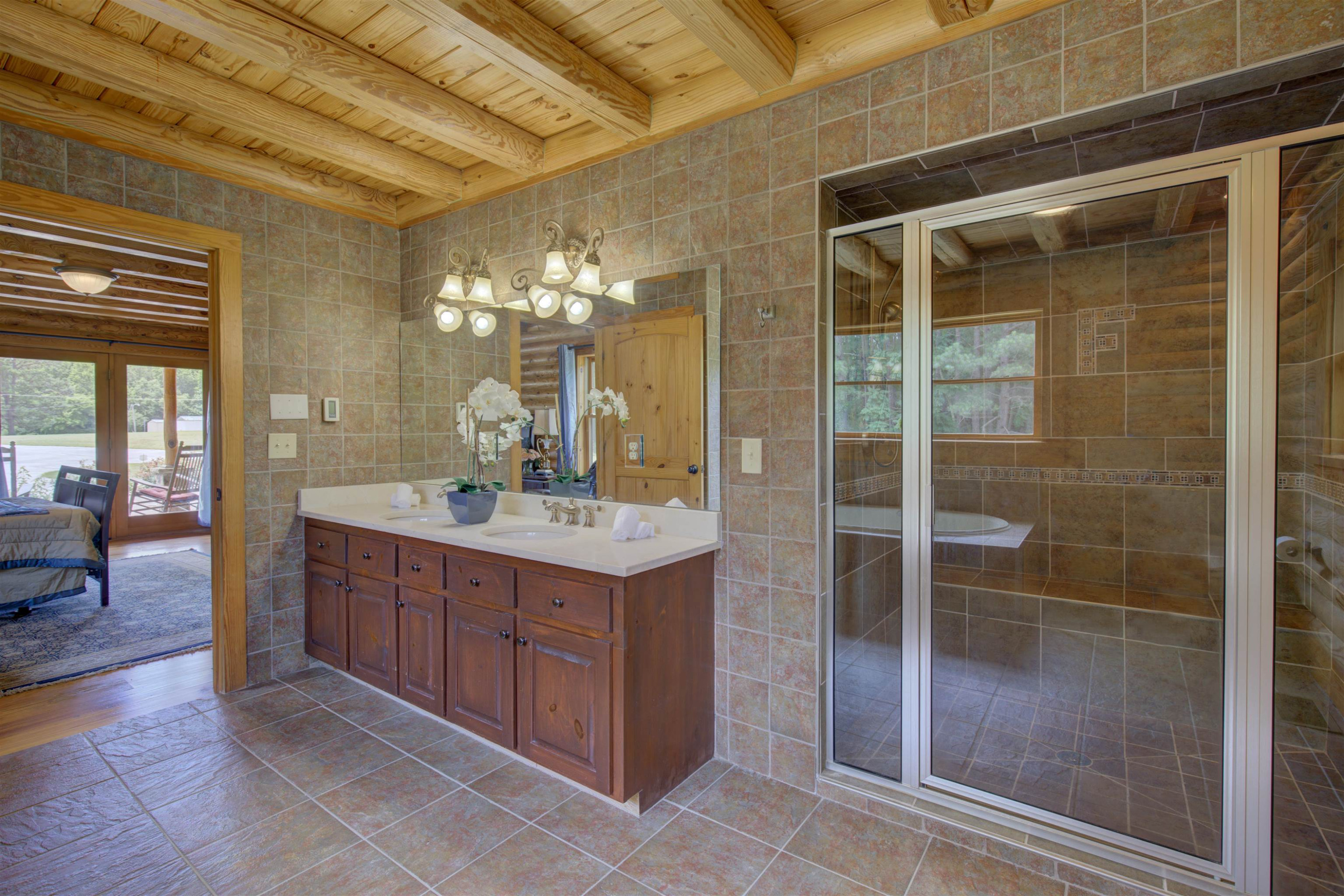 1039 North Chavis Road Kittrell, NC 27544 - Photo 23 of 53 a bathroom with a double vanity sink and a mirror