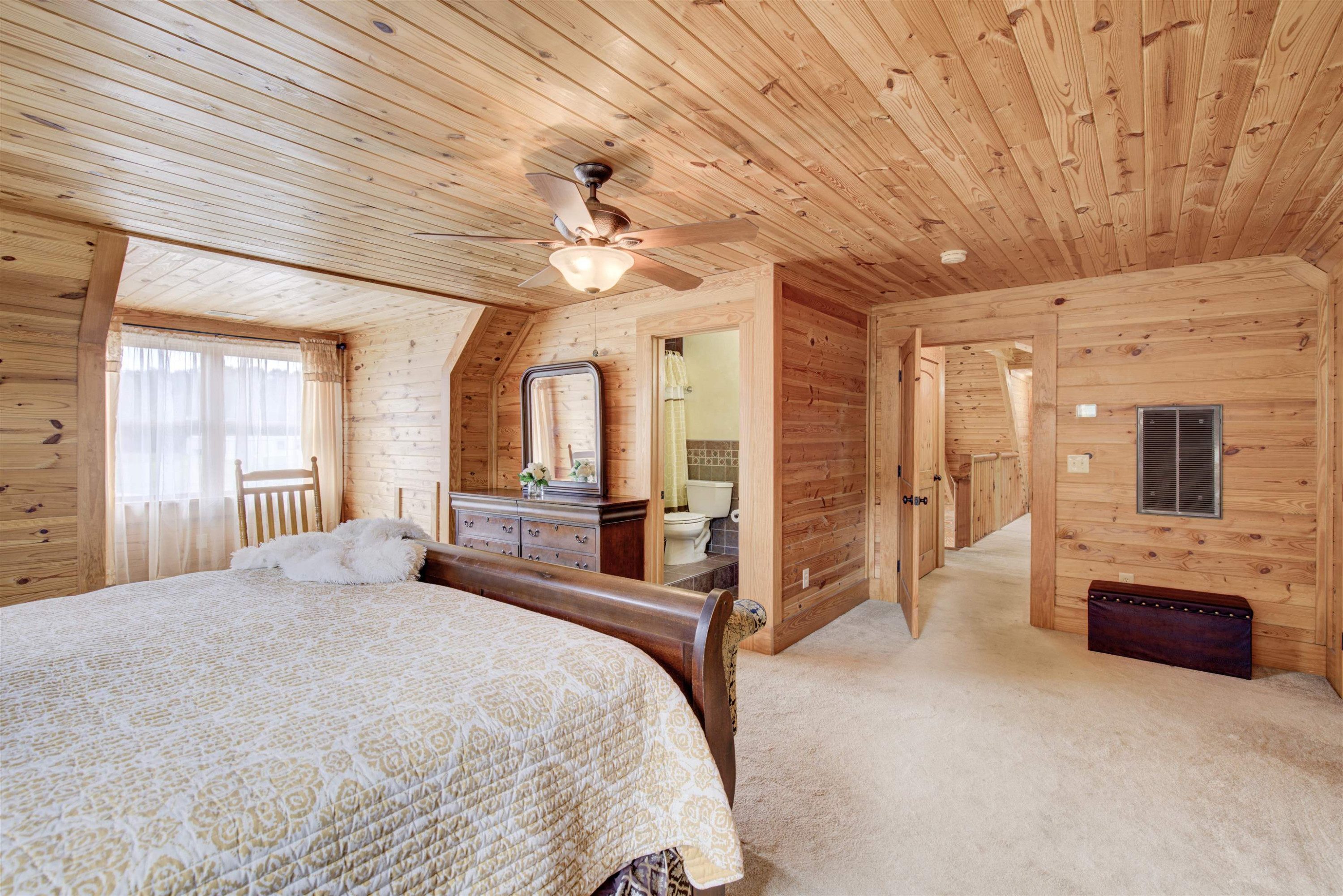 1039 North Chavis Road Kittrell, NC 27544 - Photo 25 of 53 a bedroom with a large bed a flat tv screen and dresser