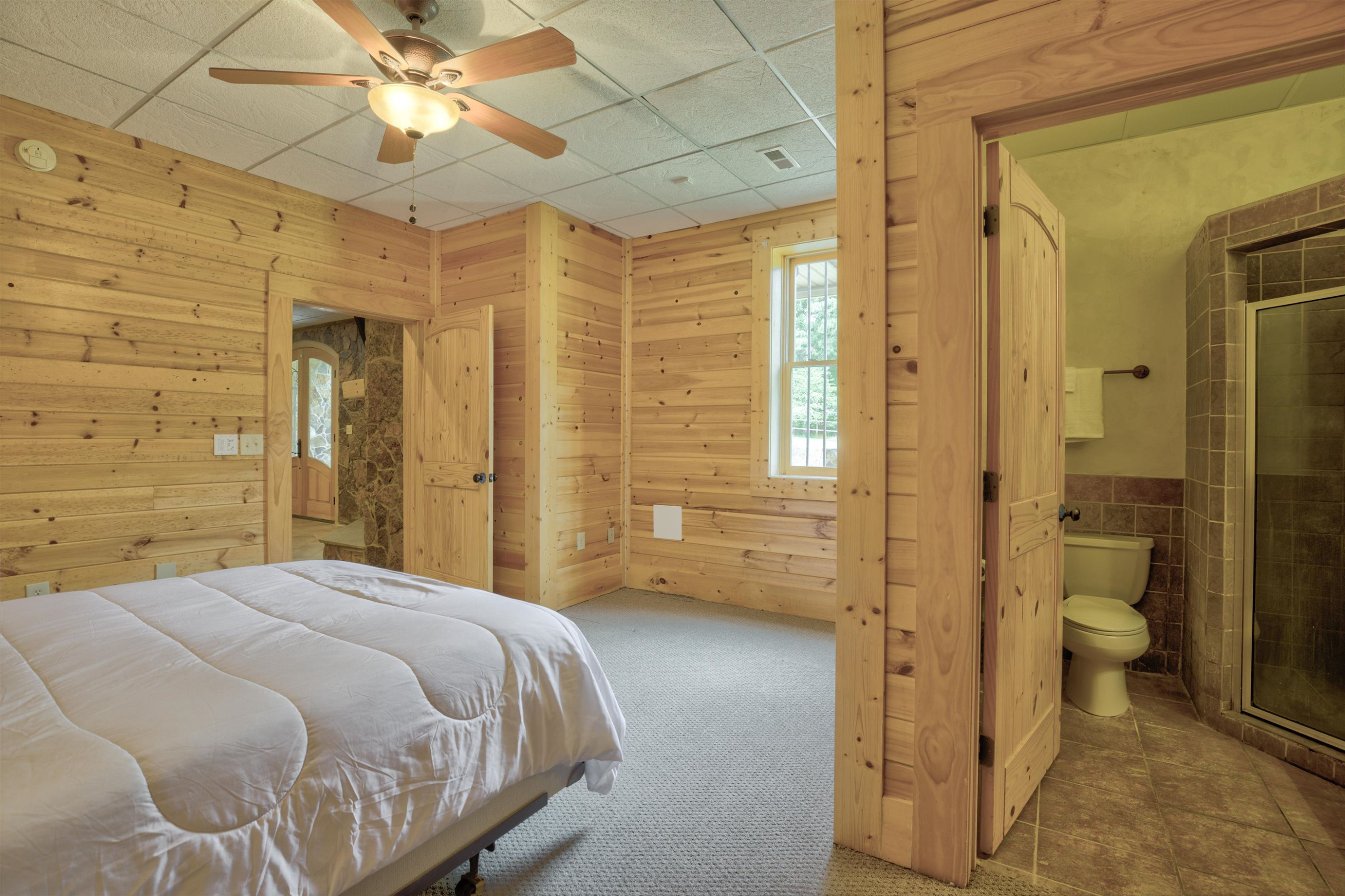 1039 North Chavis Road Kittrell, NC 27544 - Photo 35 of 53 a bedroom with a bed and a chandelier