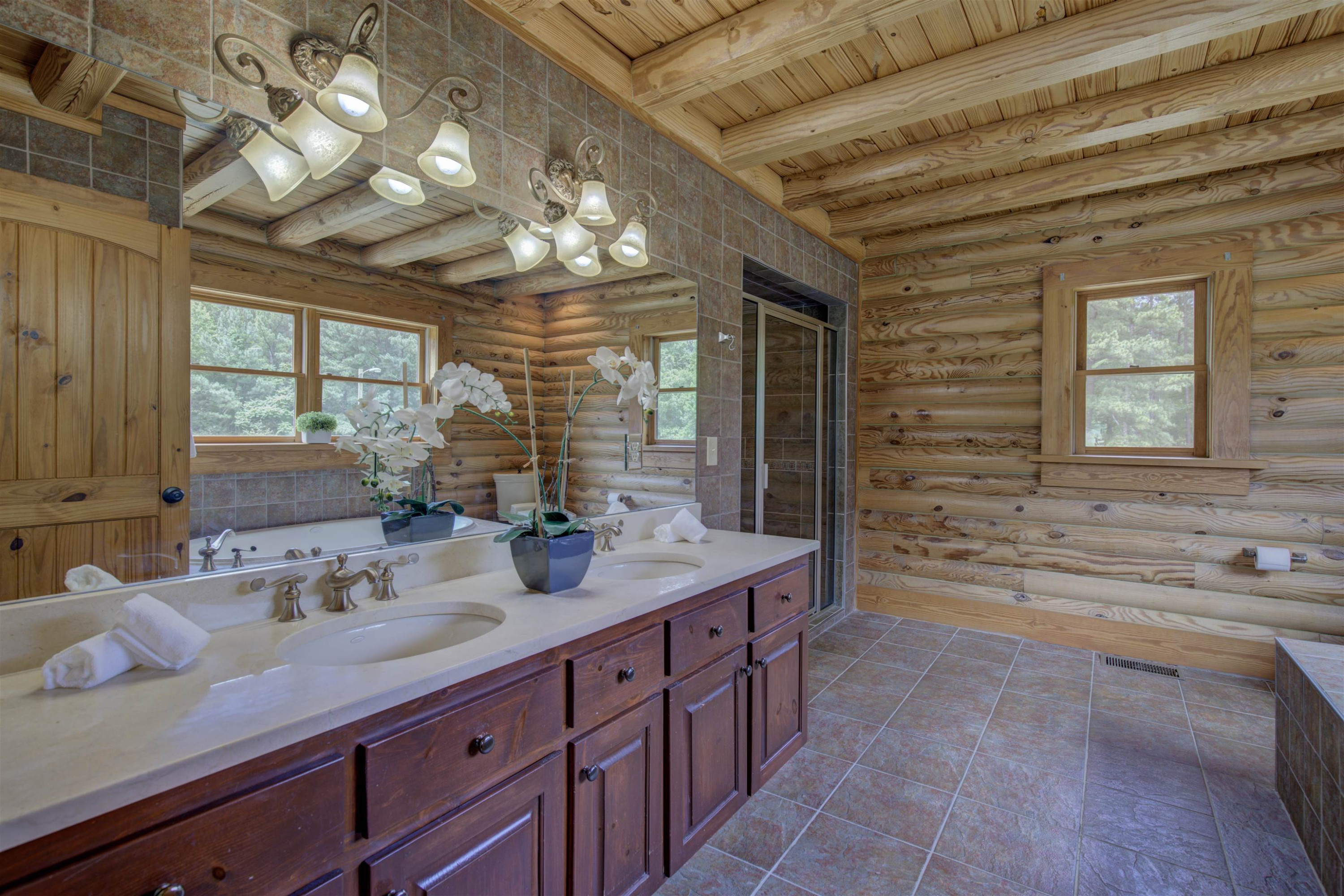 1039 North Chavis Road Kittrell, NC 27544 - Photo 10 of 53 a spacious bathroom with a sink a large mirror and a bathtub