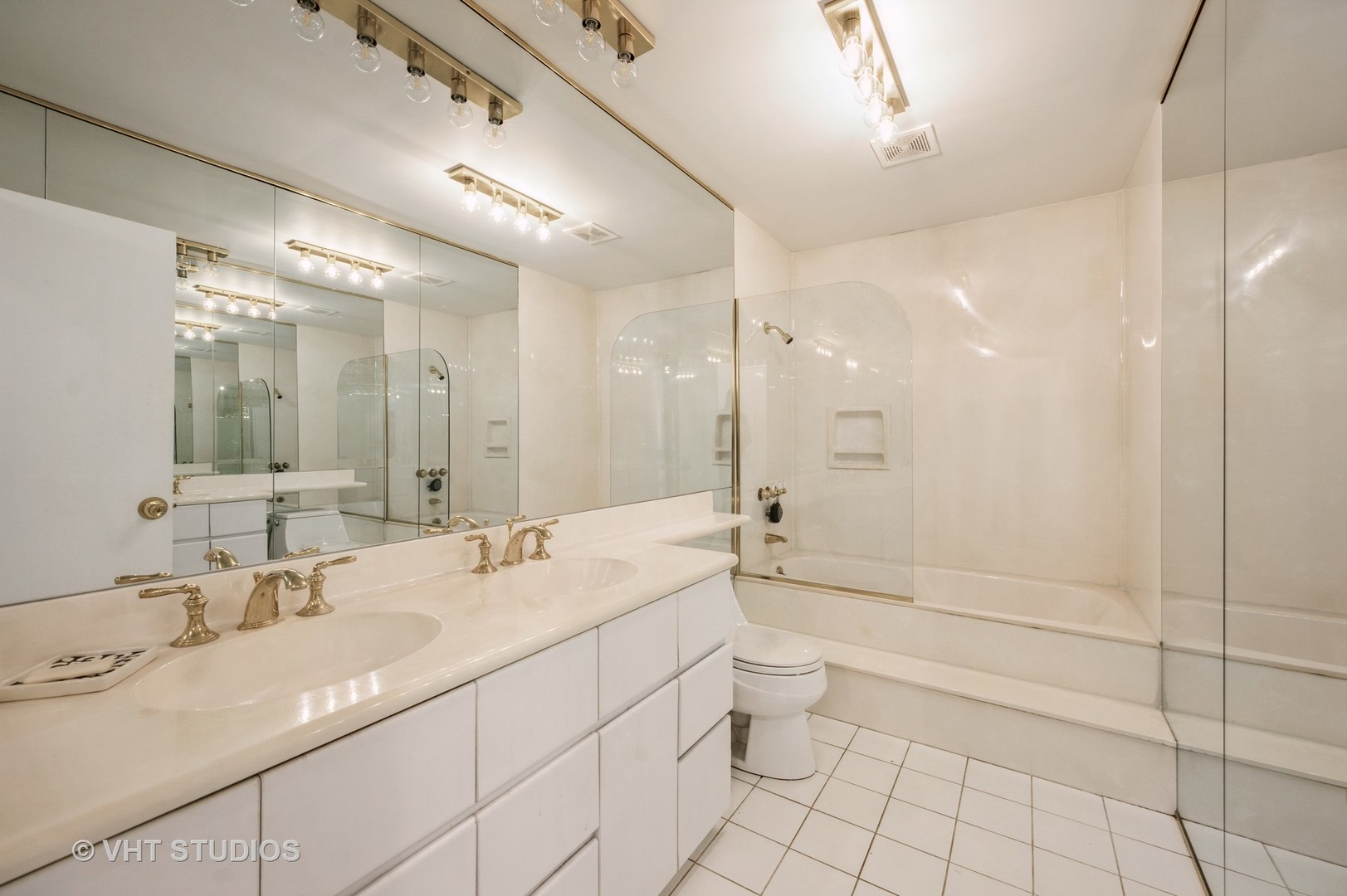 820 Barberry Road Highland Park, IL 60035 - Photo 7 of 13 a bathroom with a granite countertop sink a toilet a mirror and shower