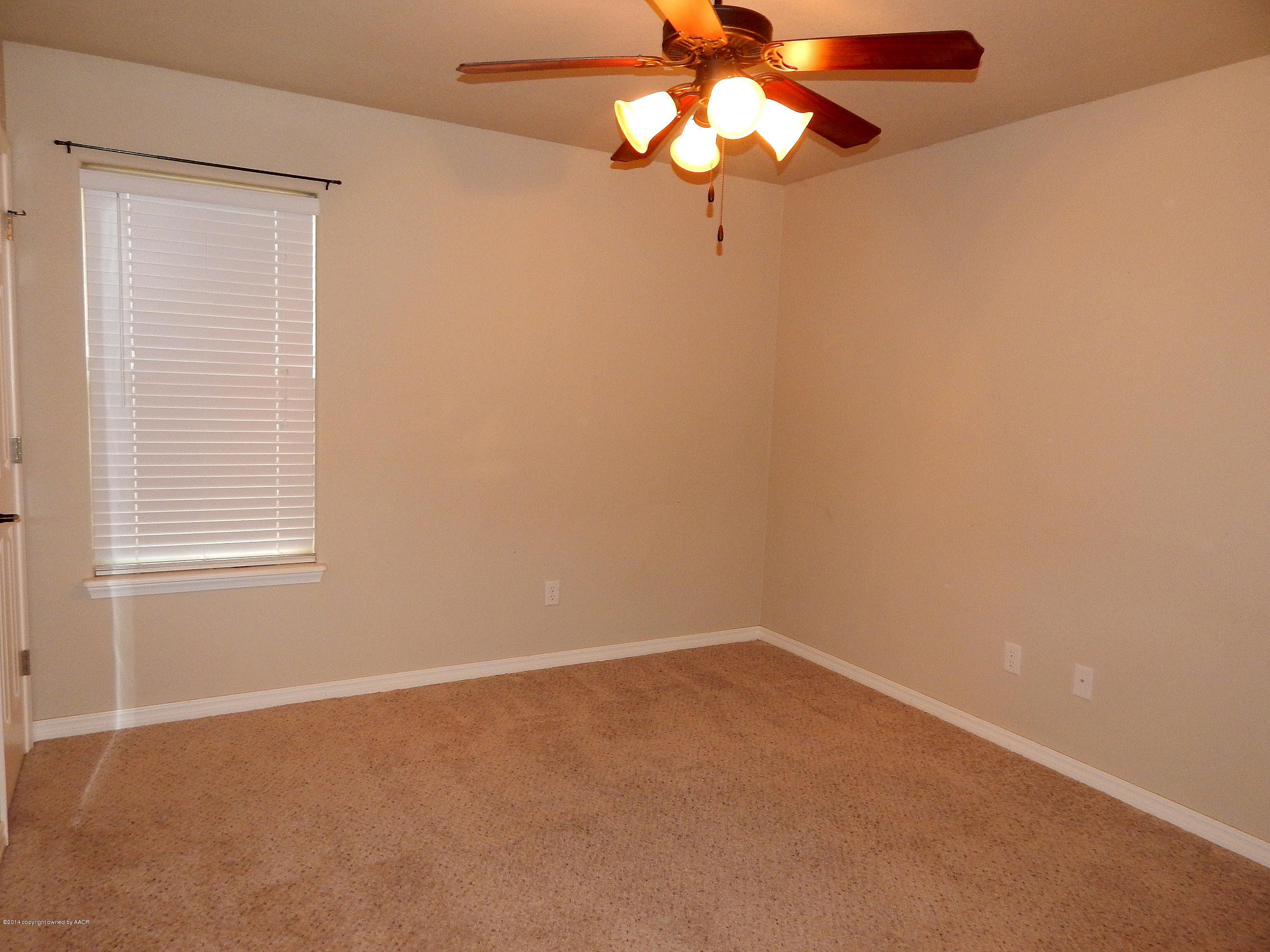 5302 Pleasant Court Amarillo, TX 79110 - Photo 21 of 22 an empty room with a window and a fan