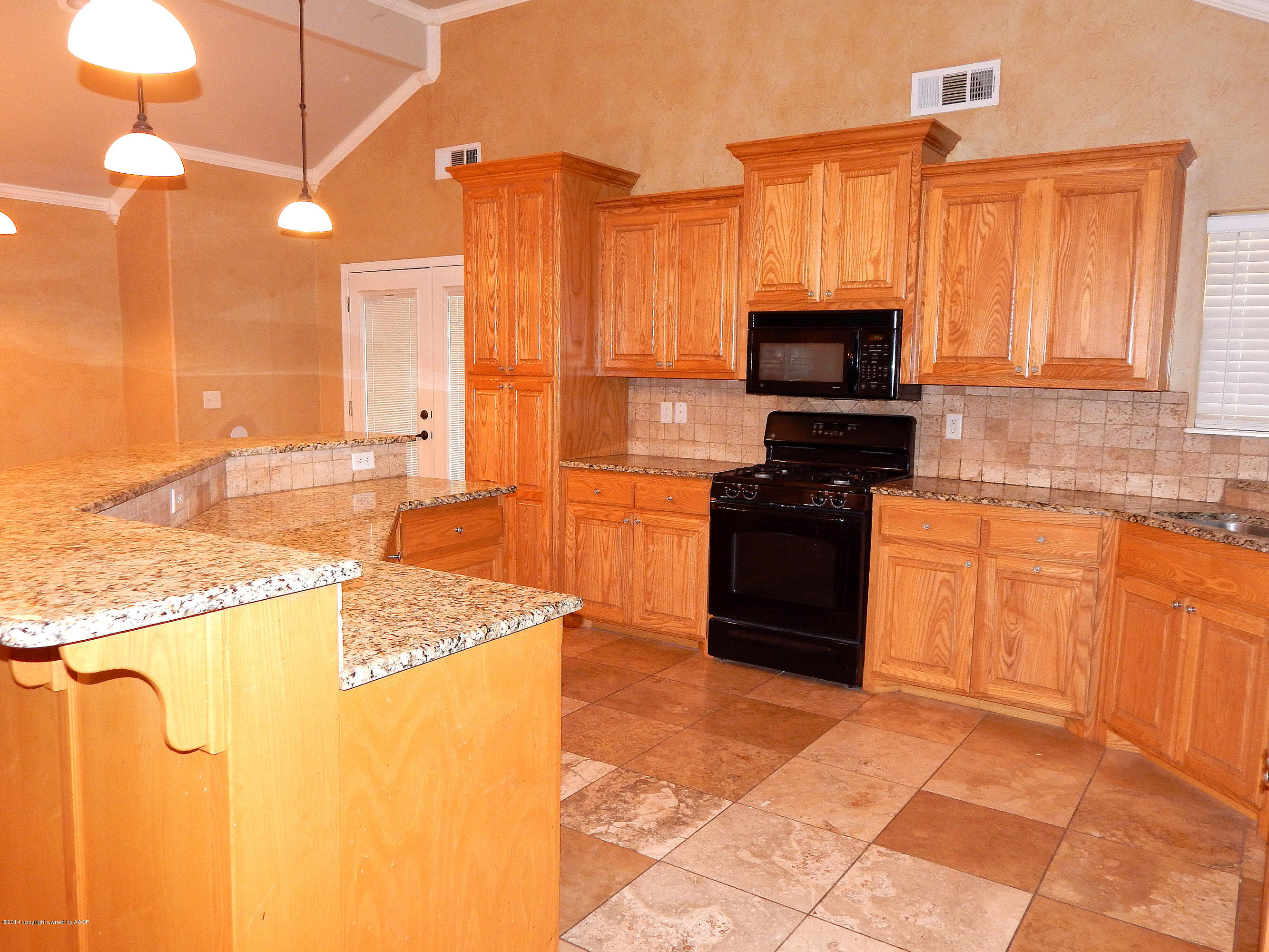 5302 Pleasant Court Amarillo, TX 79110 - Photo 7 of 22 a kitchen with stainless steel appliances granite countertop a stove a sink and a microwave