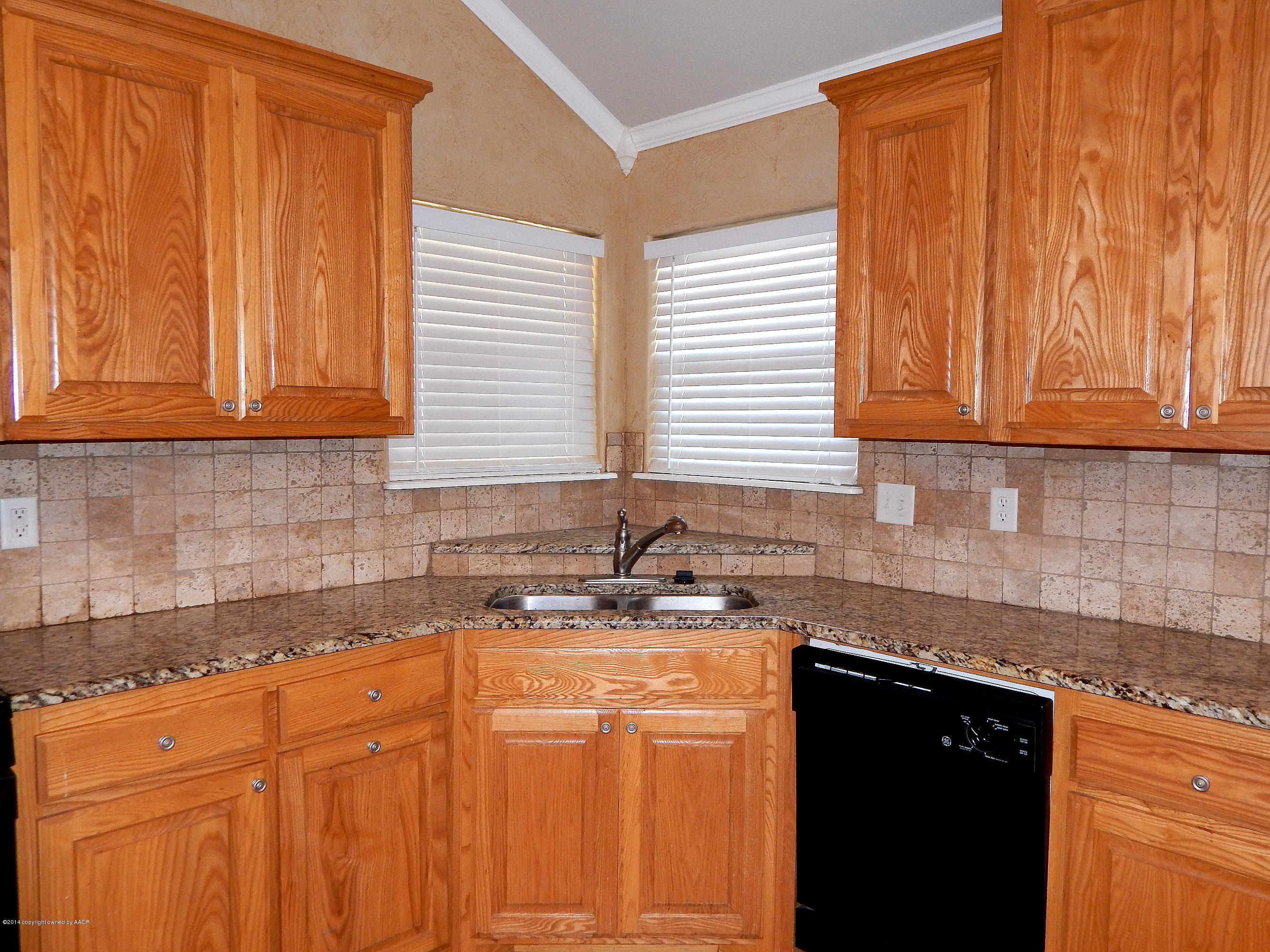5302 Pleasant Court Amarillo, TX 79110 - Photo 8 of 22 a kitchen with granite countertop cabinets sink and window