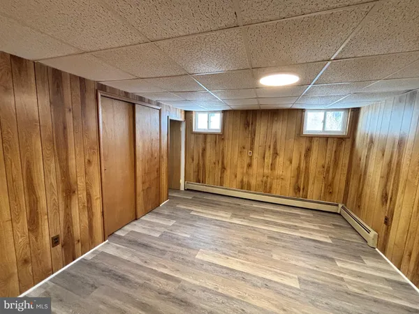 a view of kitchen with stainless steel appliances cabinets and wooden floor