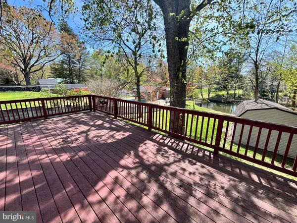 a view of a house with a yard and a lake view
