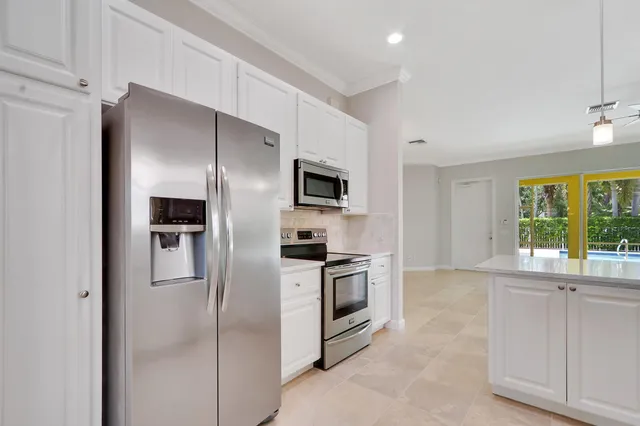 a kitchen with a sink appliances and cabinets