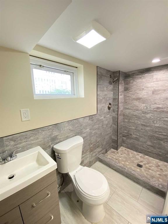 52 Day Street Clifton, NJ 07011 - Photo 14 of 19 a bathroom with a sink toilet and shower