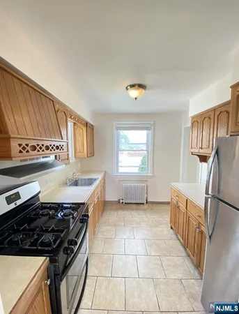 a kitchen with a stove a sink and a refrigerator