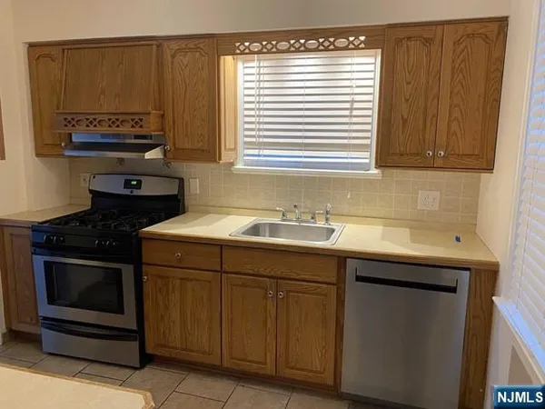 a kitchen with a sink stove and cabinets