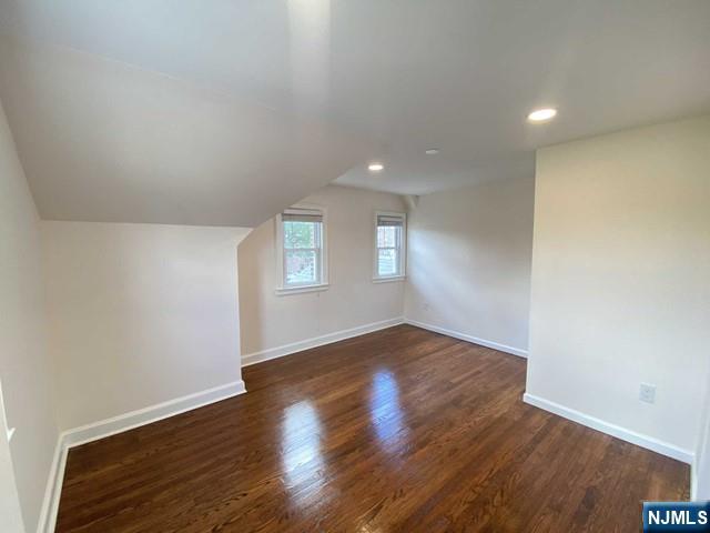 52 Day Street Clifton, NJ 07011 - Photo 8 of 19 an empty room with wooden floor and windows