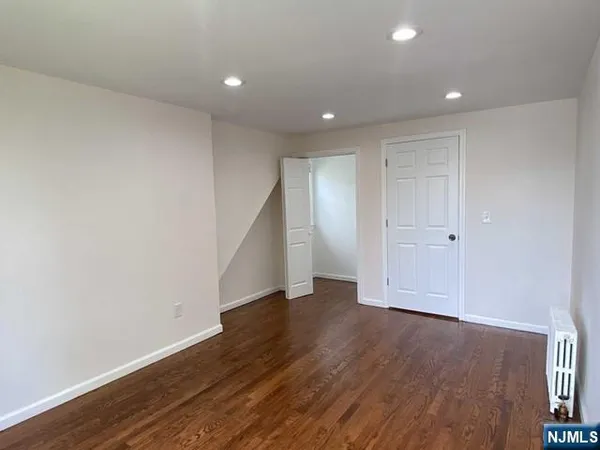 a bathroom with a toilet a sink a mirror a window and vanity