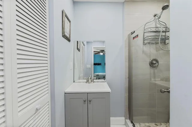 a bathroom with a shower and a sink