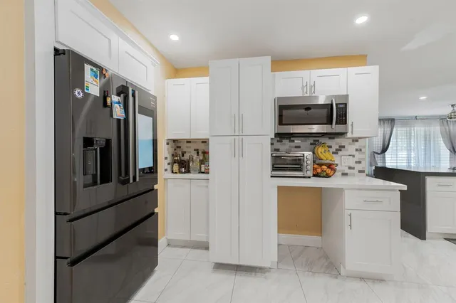 a kitchen with stainless steel appliances a refrigerator stove microwave and sink