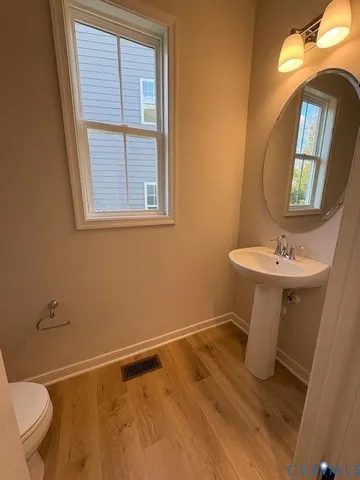 a bathroom with a sink toilet and a mirror