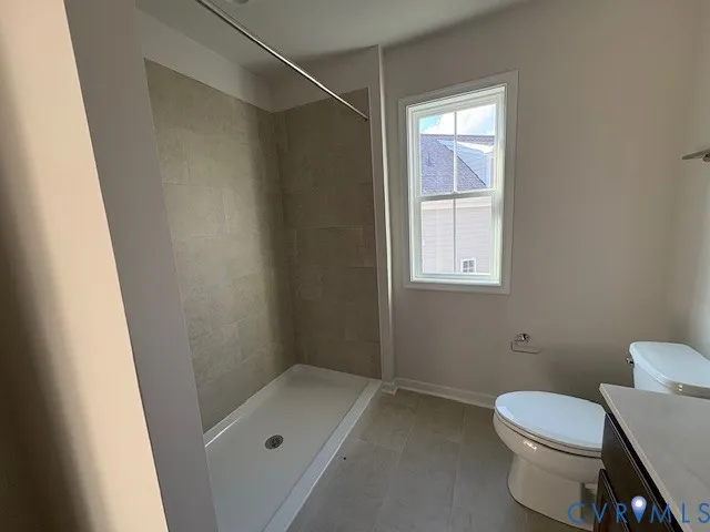 a bathroom with a toilet and a shower