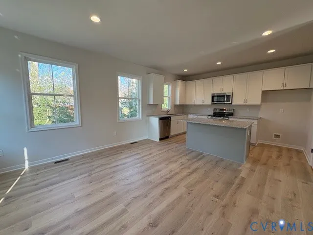 a kitchen with a refrigerator and window