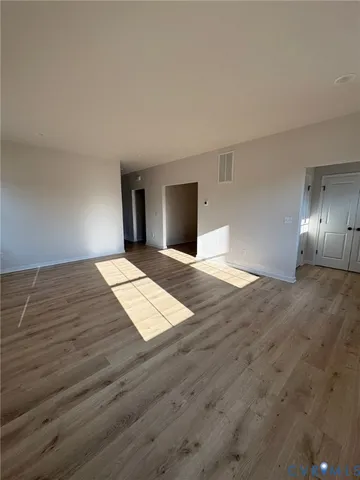 a view of wooden floor and windows in a room
