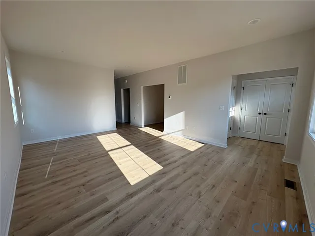 a view of wooden floor and windows in a room