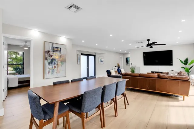 a kitchen with stainless steel appliances granite countertop a sink a stove and a refrigerator