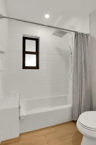 a room that has a bed and a dresser in it