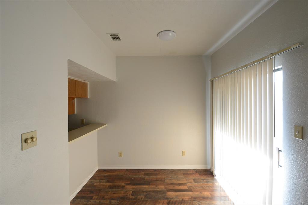 501 Arbor Creek Drive, Unit 204 Euless, TX 76039 - Photo 12 of 22 a view of an empty room with wooden floor and a window