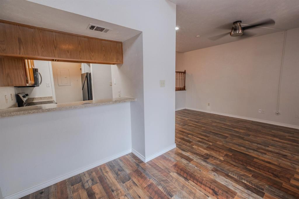501 Arbor Creek Drive, Unit 204 Euless, TX 76039 - Photo 5 of 22 a view of a hallway with wooden floor and staircase