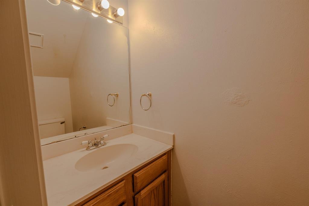 501 Arbor Creek Drive, Unit 204 Euless, TX 76039 - Photo 8 of 22 a bathroom with a sink and mirror