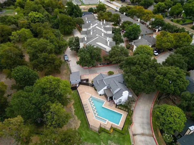an aerial view of a house with a yard and lake view