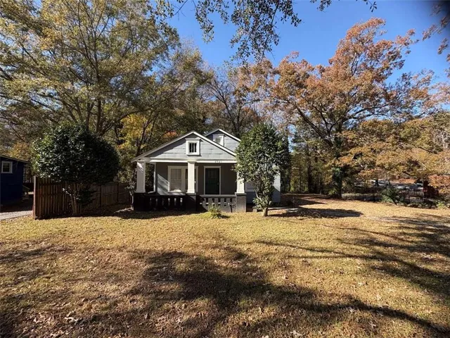 a front view of a house with a yard covered with snow