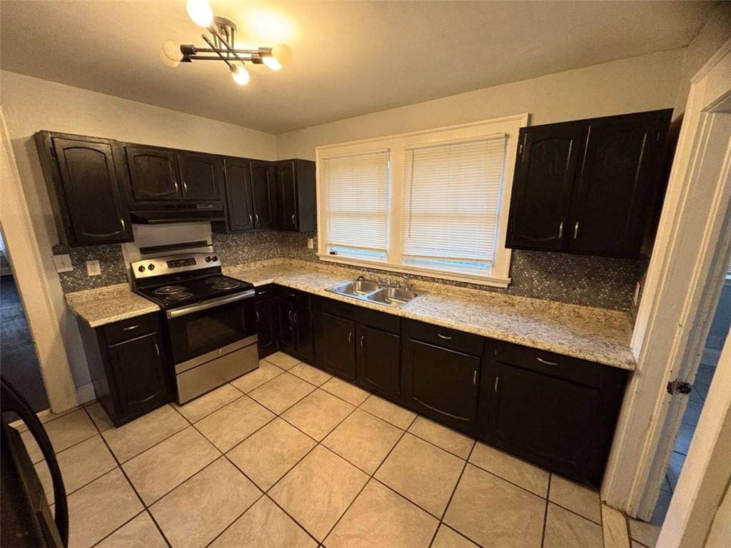 2421 Fairburn Road Southwest Atlanta, GA 30331 - Photo 13 of 15 a kitchen with granite countertop a refrigerator and a sink