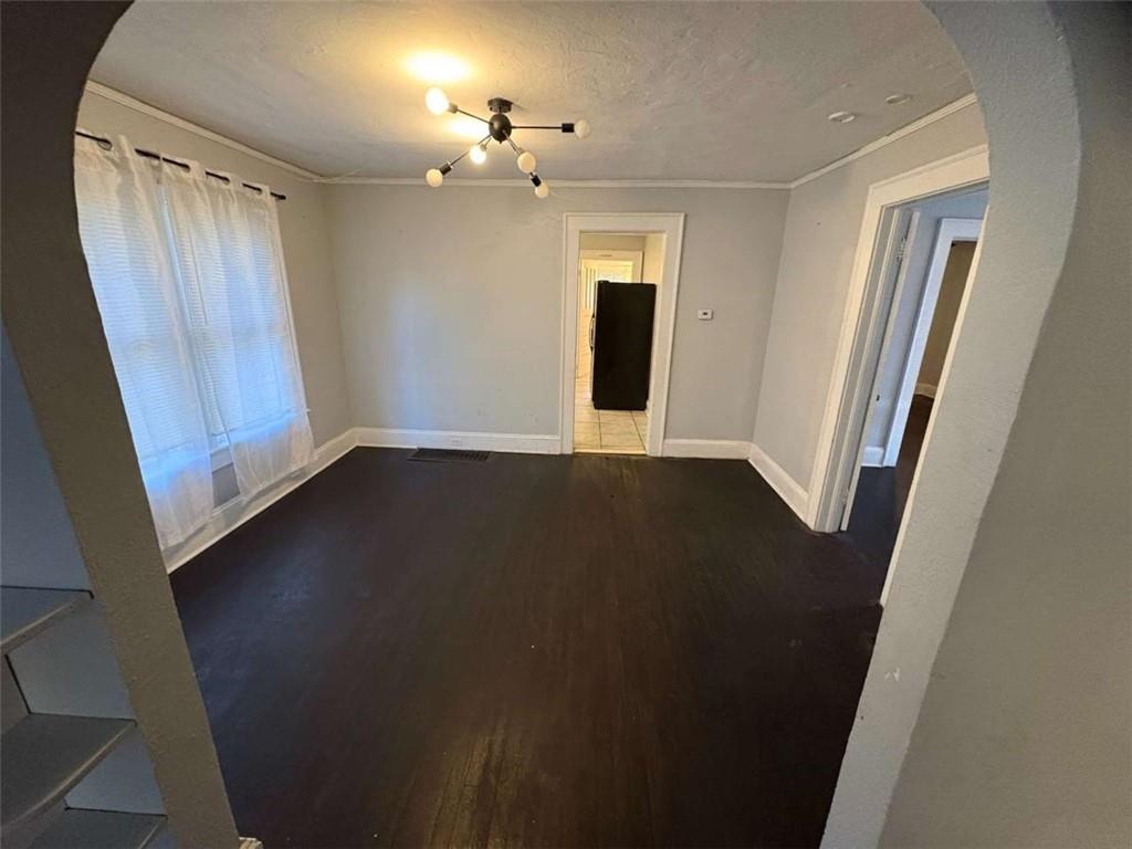 2421 Fairburn Road Southwest Atlanta, GA 30331 - Photo 5 of 15 an empty room with wooden floor and windows