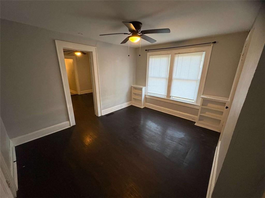 2421 Fairburn Road Southwest Atlanta, GA 30331 - Photo 7 of 15 an empty room with wooden floor and windows