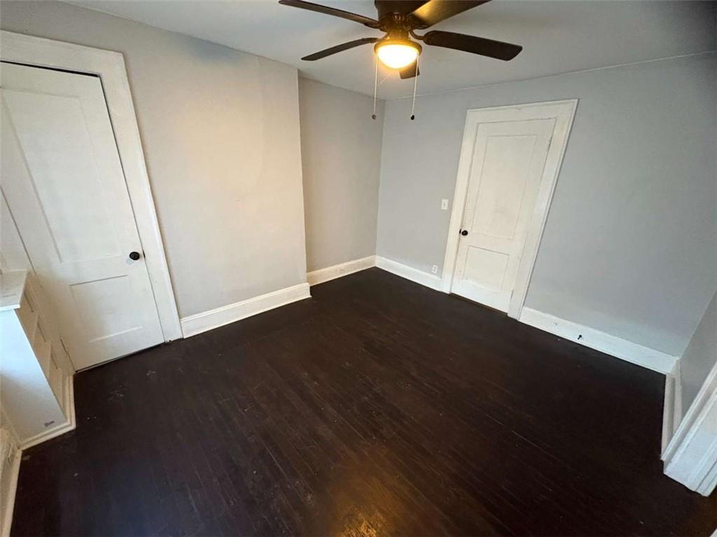 2421 Fairburn Road Southwest Atlanta, GA 30331 - Photo 8 of 15 an empty room with wooden floor and fan