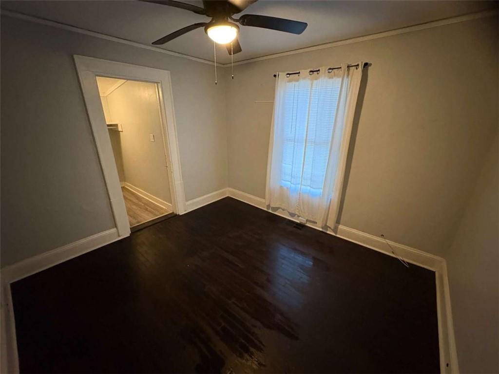 2421 Fairburn Road Southwest Atlanta, GA 30331 - Photo 10 of 15 an empty room with wooden floor and fan