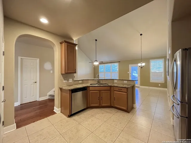 a kitchen with stainless steel appliances granite countertop a stove and a refrigerator