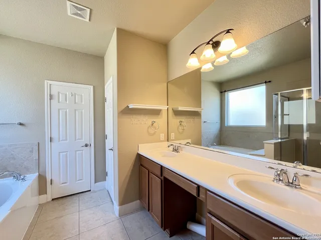 a bathroom with a sink a vanity and a mirror