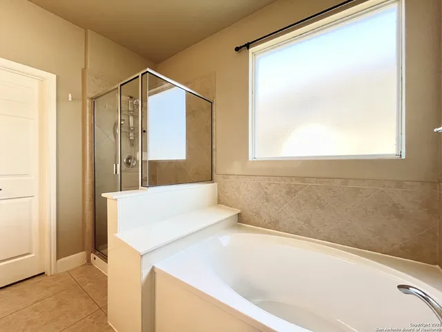 a bathroom with a bathtub and a shower