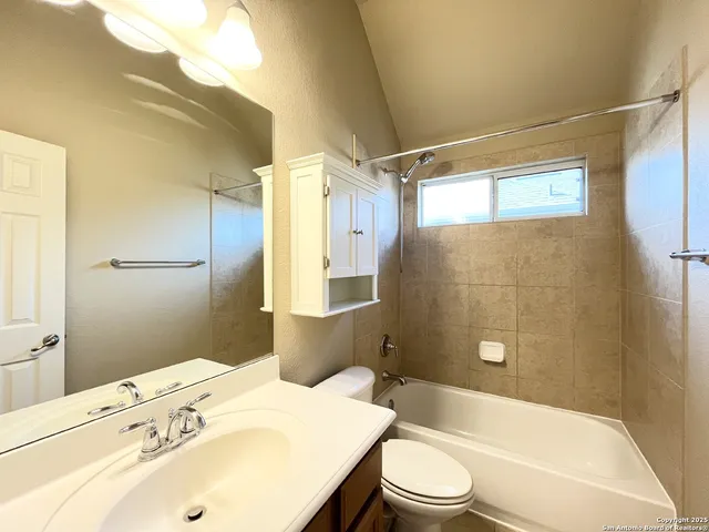 a bathroom with a sink mirror toilet and bathtub