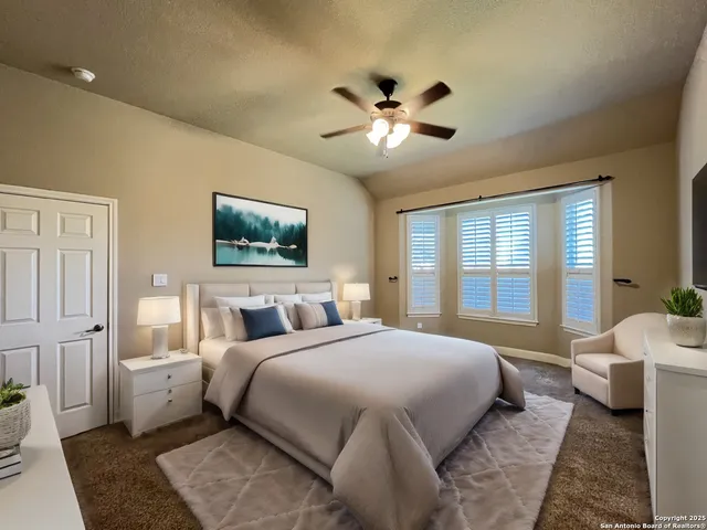 a bedroom with a large bed and a chandelier